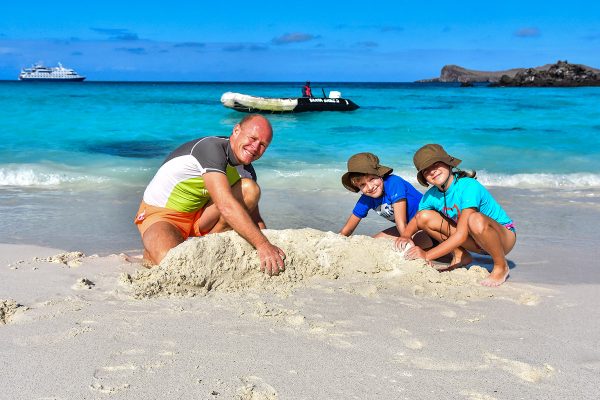Family playing at the beach in Galapagos, Ecuador